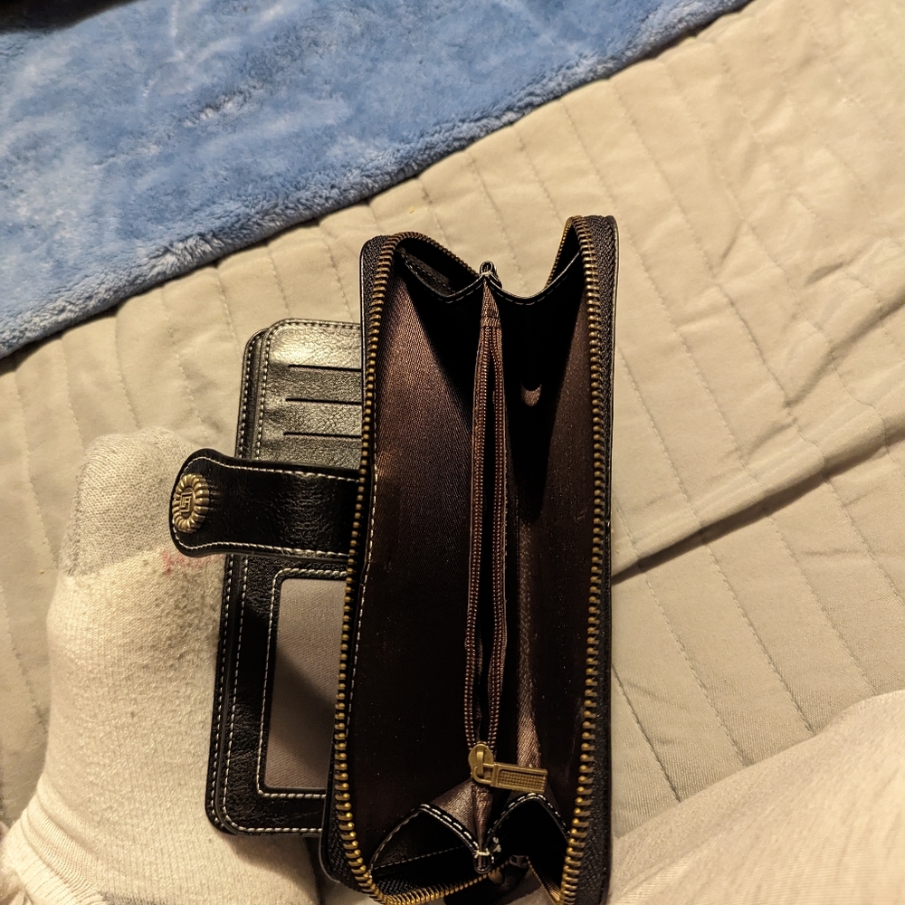 Wallet has many cards slots 2 pages of card slots and big zipper area